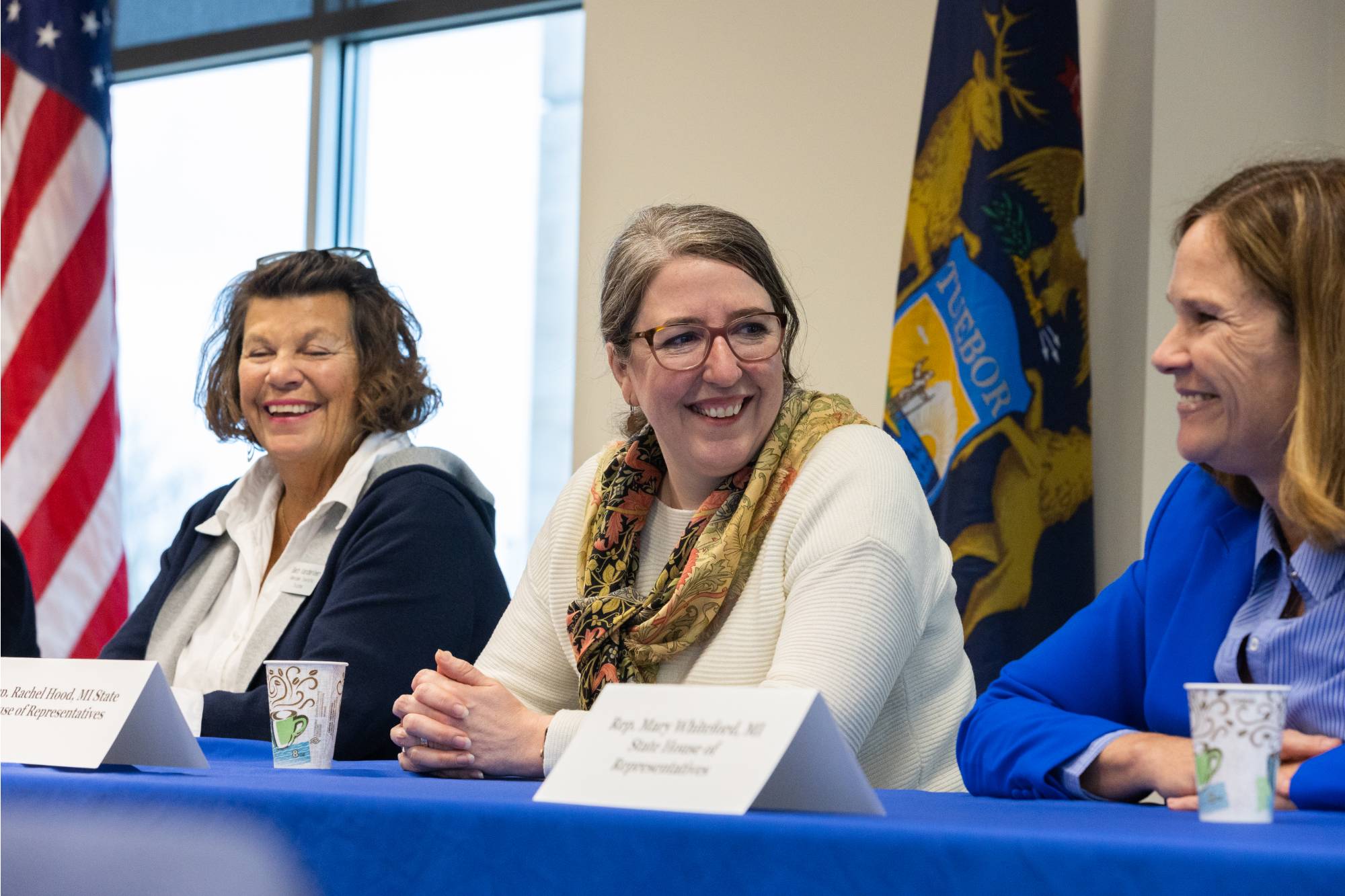 Three women smiling and talking